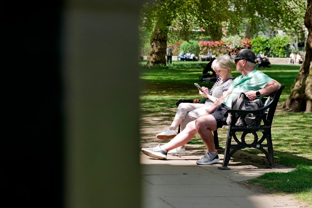 Two people having a meaningful conversation outdoors on a park bench